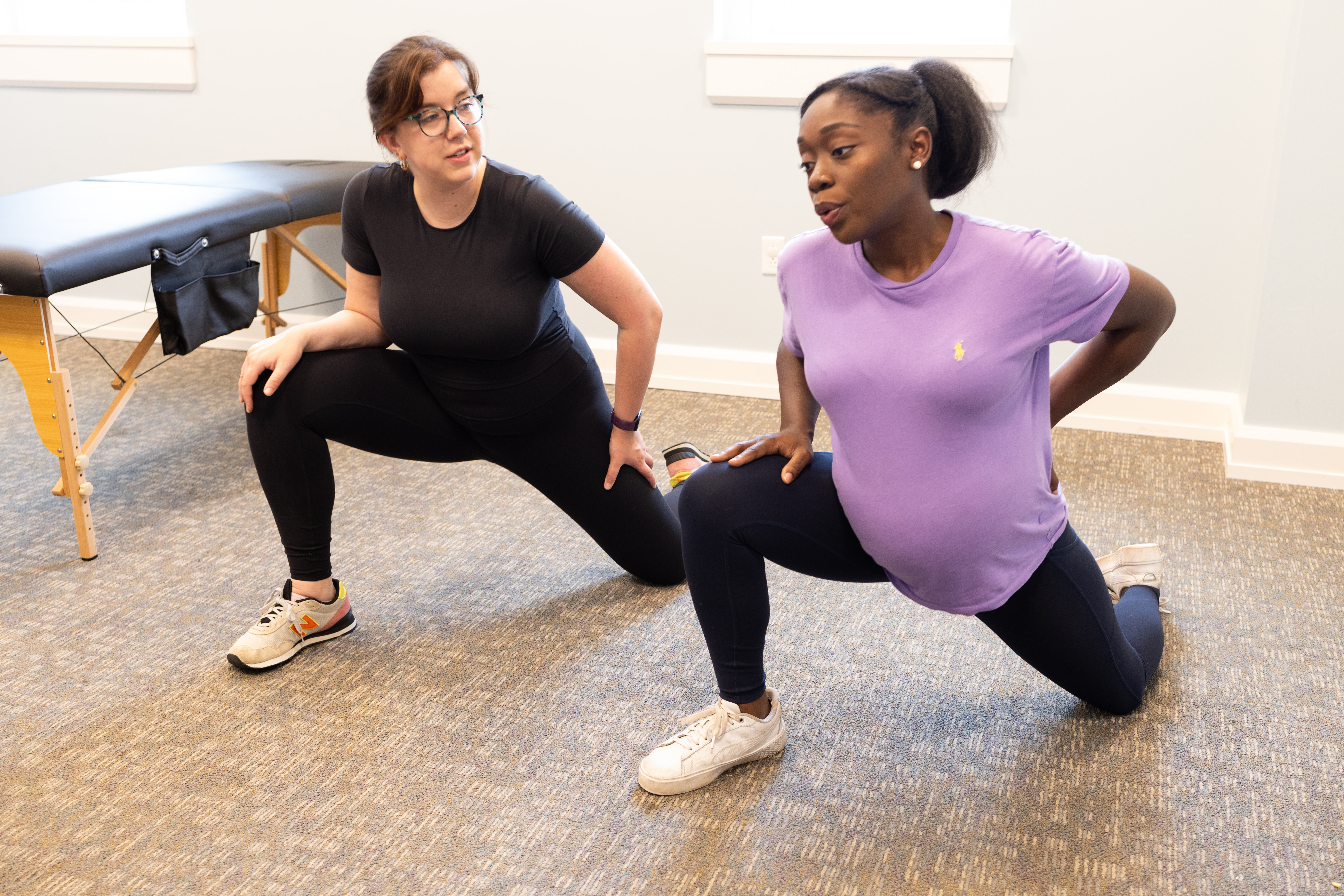 Physical Therapist and a pregnant woman doing lunges